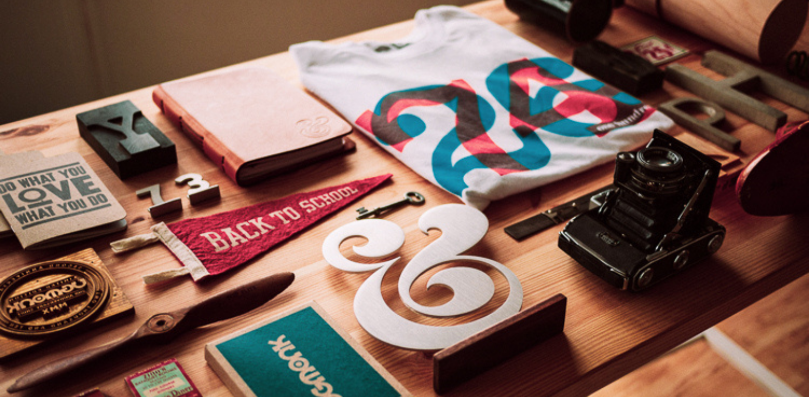 Desk covered in products with visual branding, logos and various typography