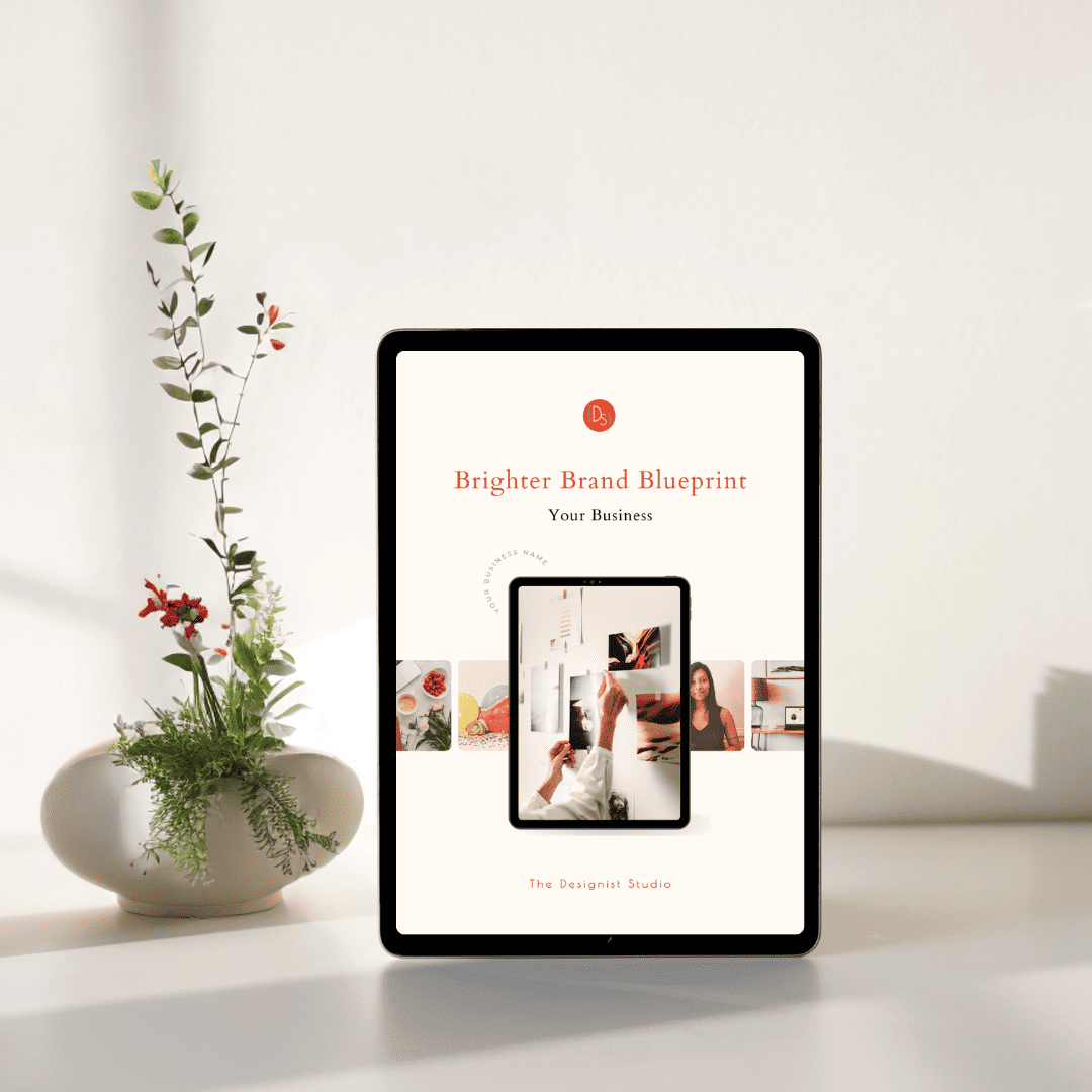 A Brand Blueprint brief cover shown on a tablet with a placeholder for Your Business Name. A delicate botanical arrangement in a small pot is beside the tablet.